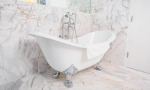 The Raphael Suite features a white tiled bathroom with a beautiful claw foot tub.